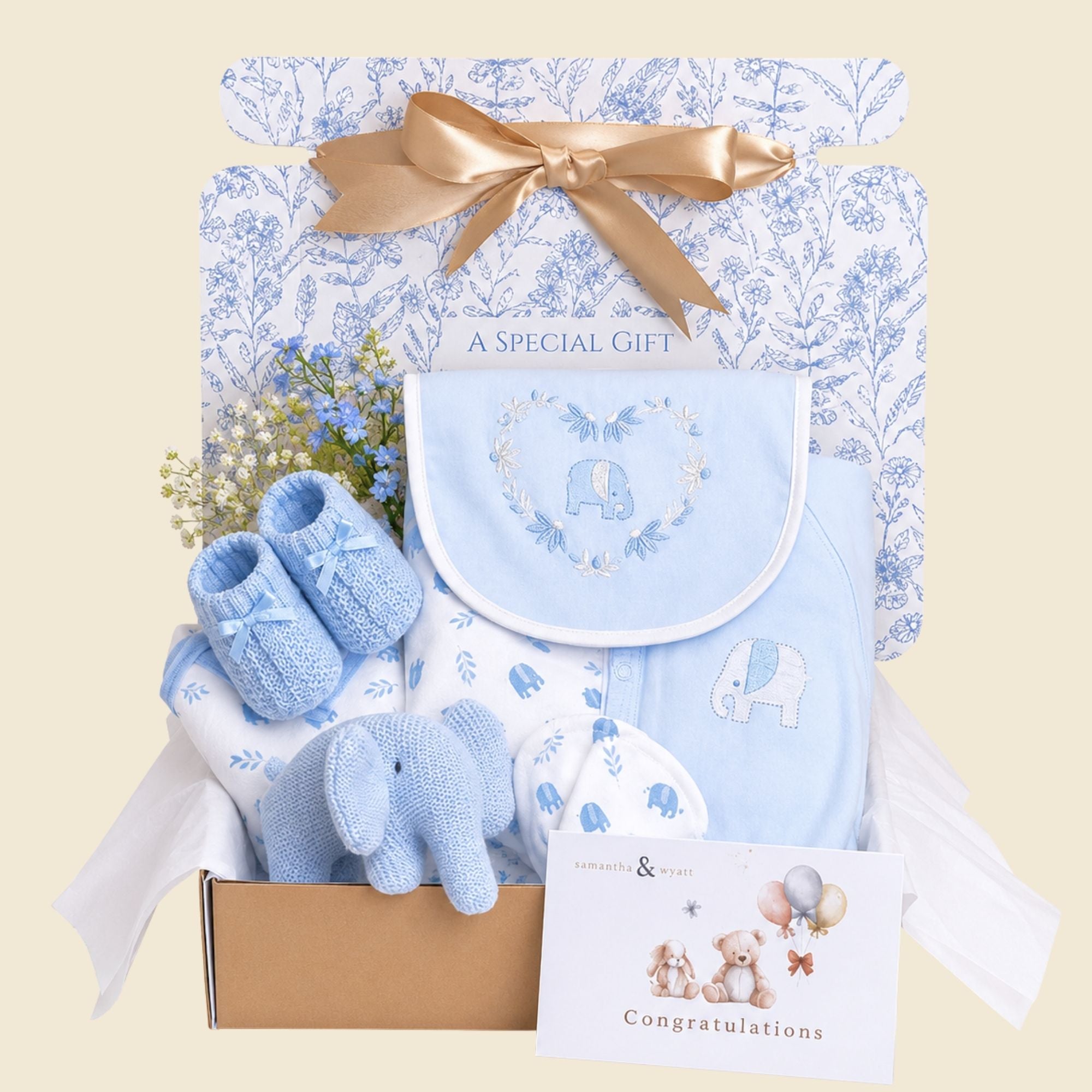 Baby boy gifts hamper with an organic elephant soft toy and baby clothing.