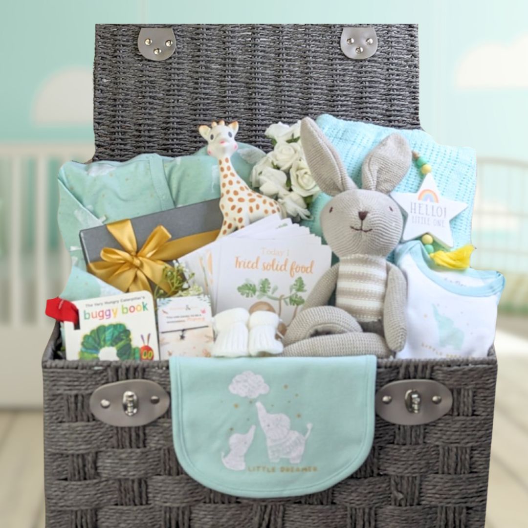baby boy gifts hamper with mint green clothing set and treats for the new parents.