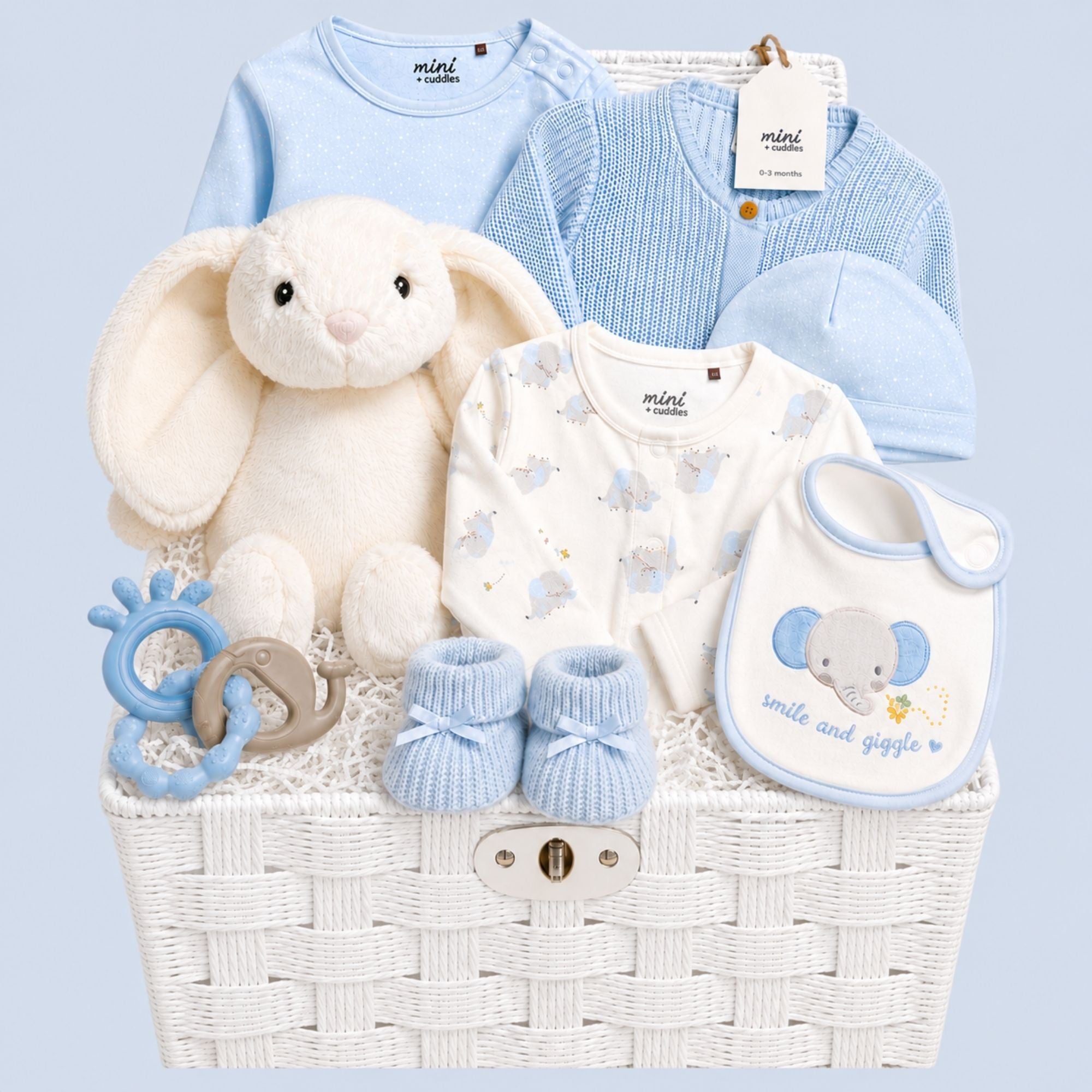 A baby boy gifts hamper with a blue and white elephant clothing set and an adorable large white bunny