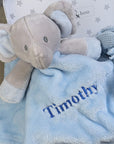 baby boy gifts trunk with blue elephant comforter blanket, blue knit baby booties and scratch mittens.