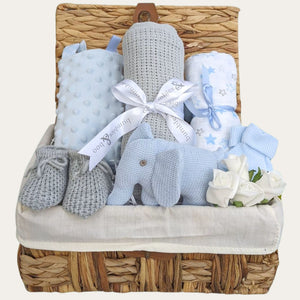Gifts for a new baby boy in a hamper basket with grey and blue presents includes elephant rattle. Bumbles and Boo.