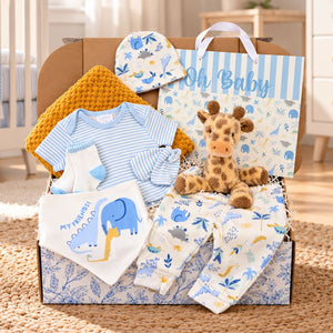 Baby boy gift hamper with My Friends blue animal-print six-piece outfit, mustard waffle blanket, recycled plush giraffe and Oh Baby gift bag.
