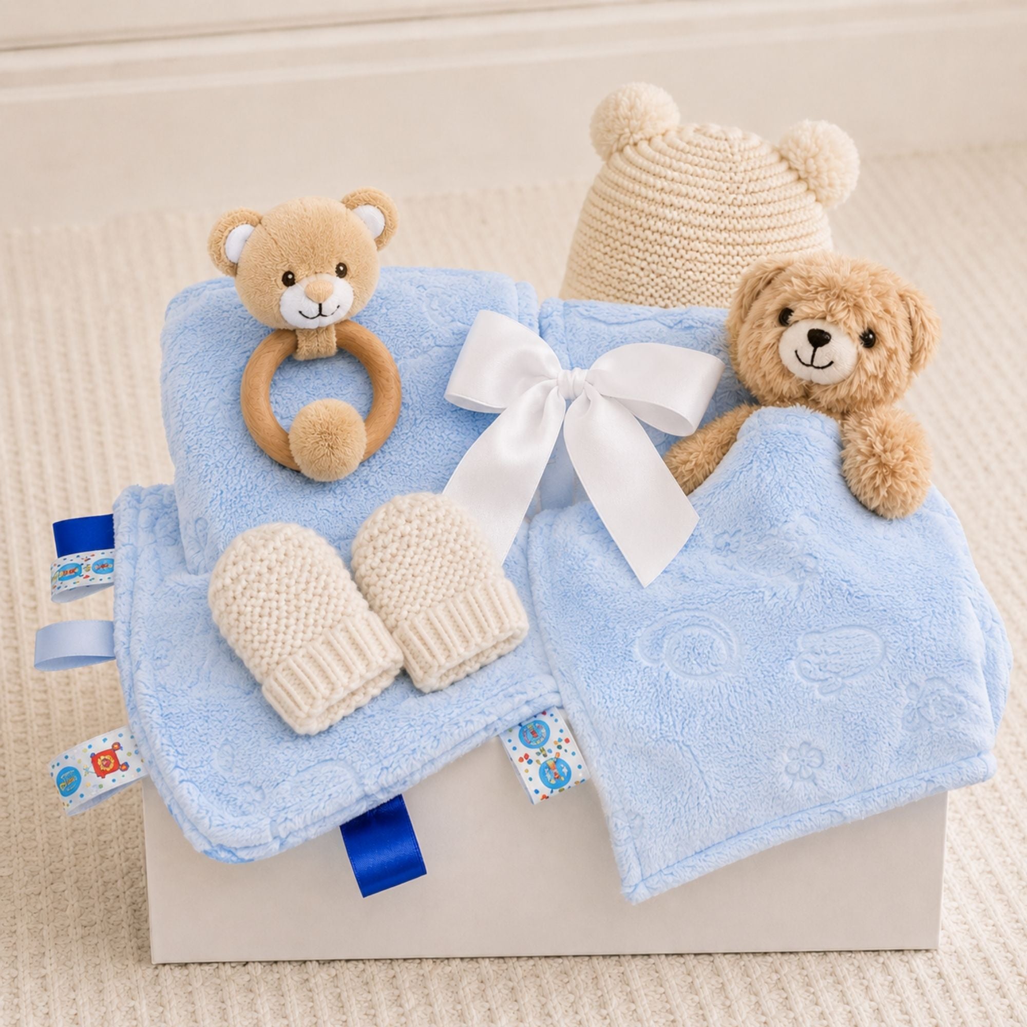 Baby boy gifts box with blue teddy theme and katie loxton hat and mittens set in a gift box.