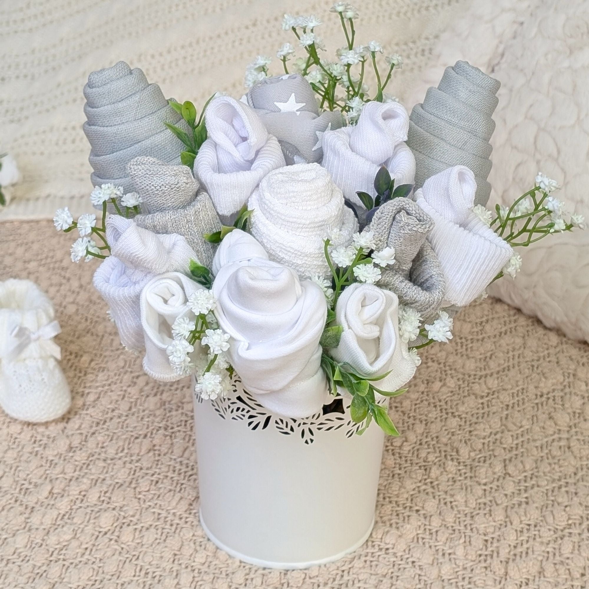 New baby flower gifts bouquet with grey and white blooms made of baby clothes and gifts by Bumbles and Boo.