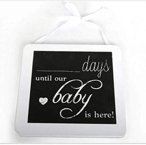 Hanging baby countdown plaque with a black panel, white ribbon and space to write the days.