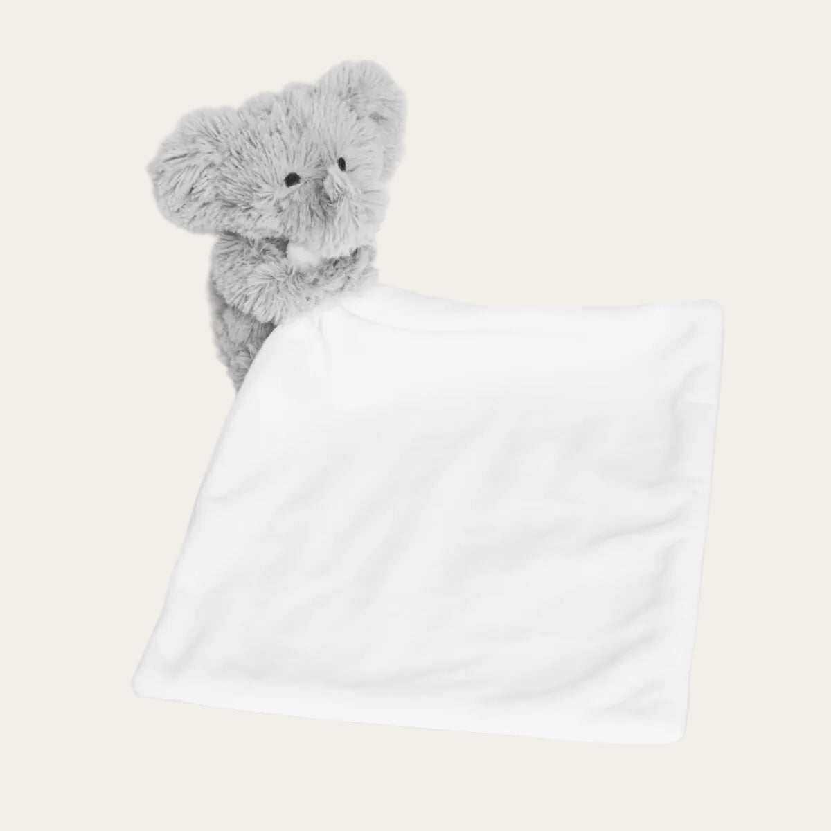 Elephant soft toy attached to baby comforter blanket
