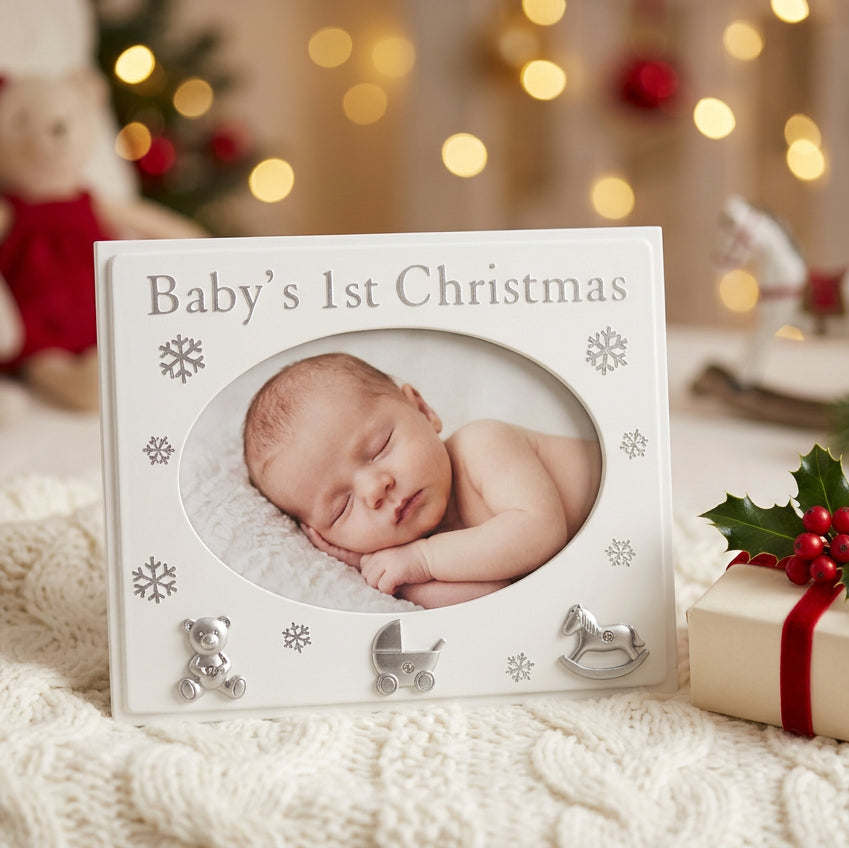Baby's 1st Christmas silver-white photo frame with snowflakes and teddy, pram and rocking horse details.