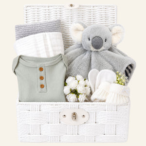 New baby gifts basket with white and grey presents. This baby hamper includes soft koala comforter toy and baby essentials. Bumbles and Boo.