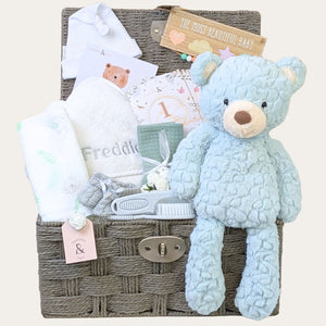 Baby gifts hamper basket with practical presents including hooded towel and large plush mint teddy bear. Bumbles and Boo. 