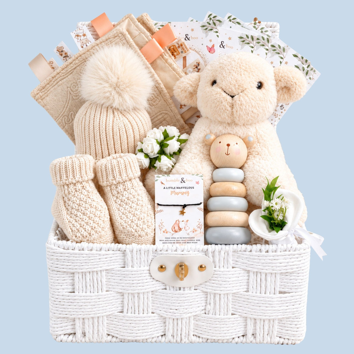 New baby gifts basket with soft beige and cream tones and includes a lamb plus toy.