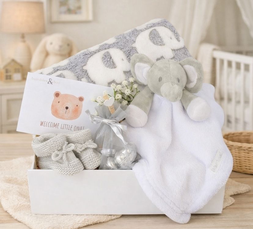 Baby gifts box with a grey elephant blanket and white elephant comforter with a gift for mum.