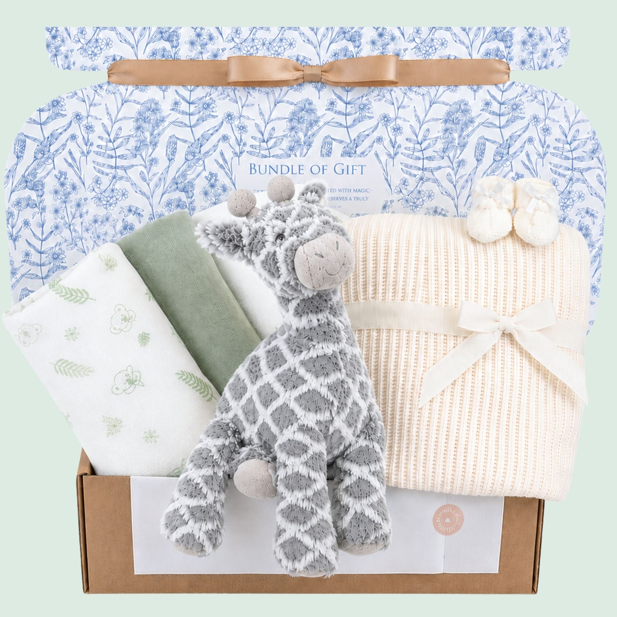 A baby gifts box to welcome a new baby. This hamper gift includes a grey giraffe soft toy and cream baby blanket.