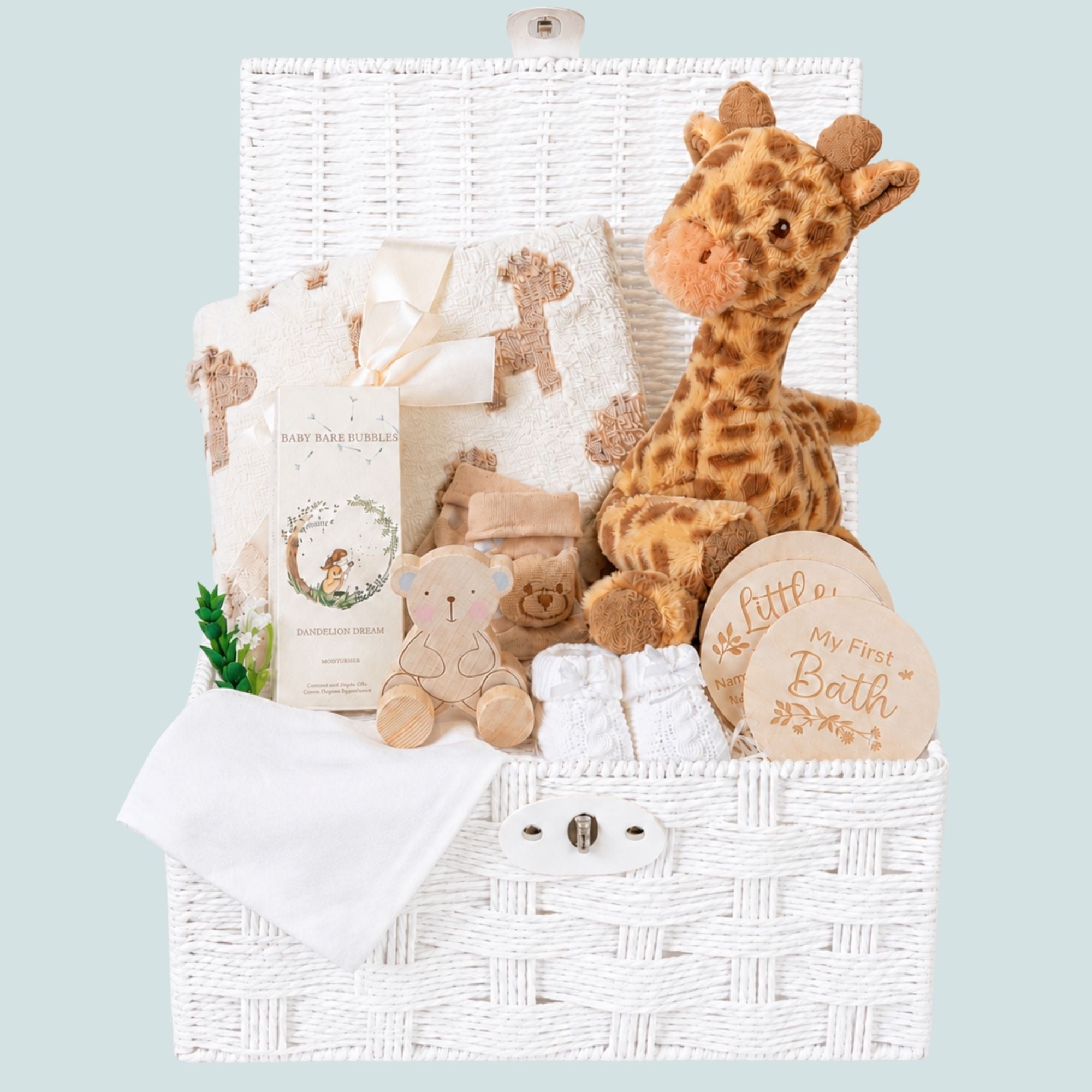 Baby hamper gifts for a newborn with giraffe soft toy and skincare in a hamper basket.