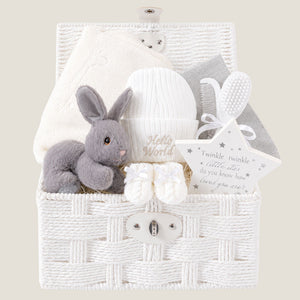 Baby Hamper Basket with gifts including grey bunny rabbit and a white blanket which can be personalised with baby's name.