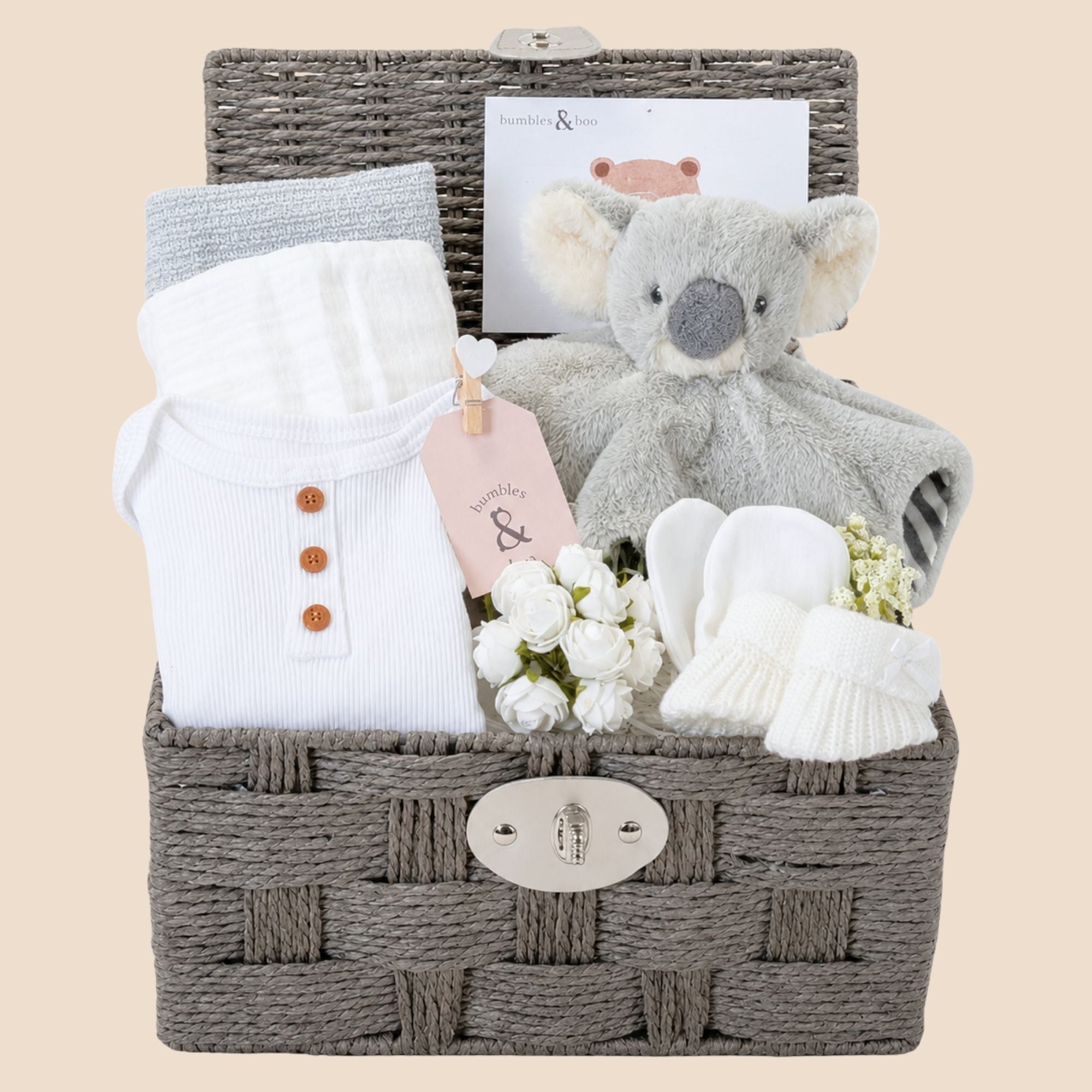 New baby gifts basket with white and grey presents. This baby hamper includes soft koala comforter toy and baby essentials. Bumbles and Boo.