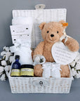 new baby gifts in a white hamper basket.