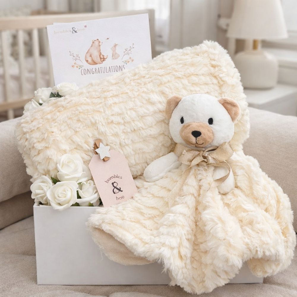 Baby gift hamper in cream. This gift set includes a plush teddy bear, and plush cream baby blanket