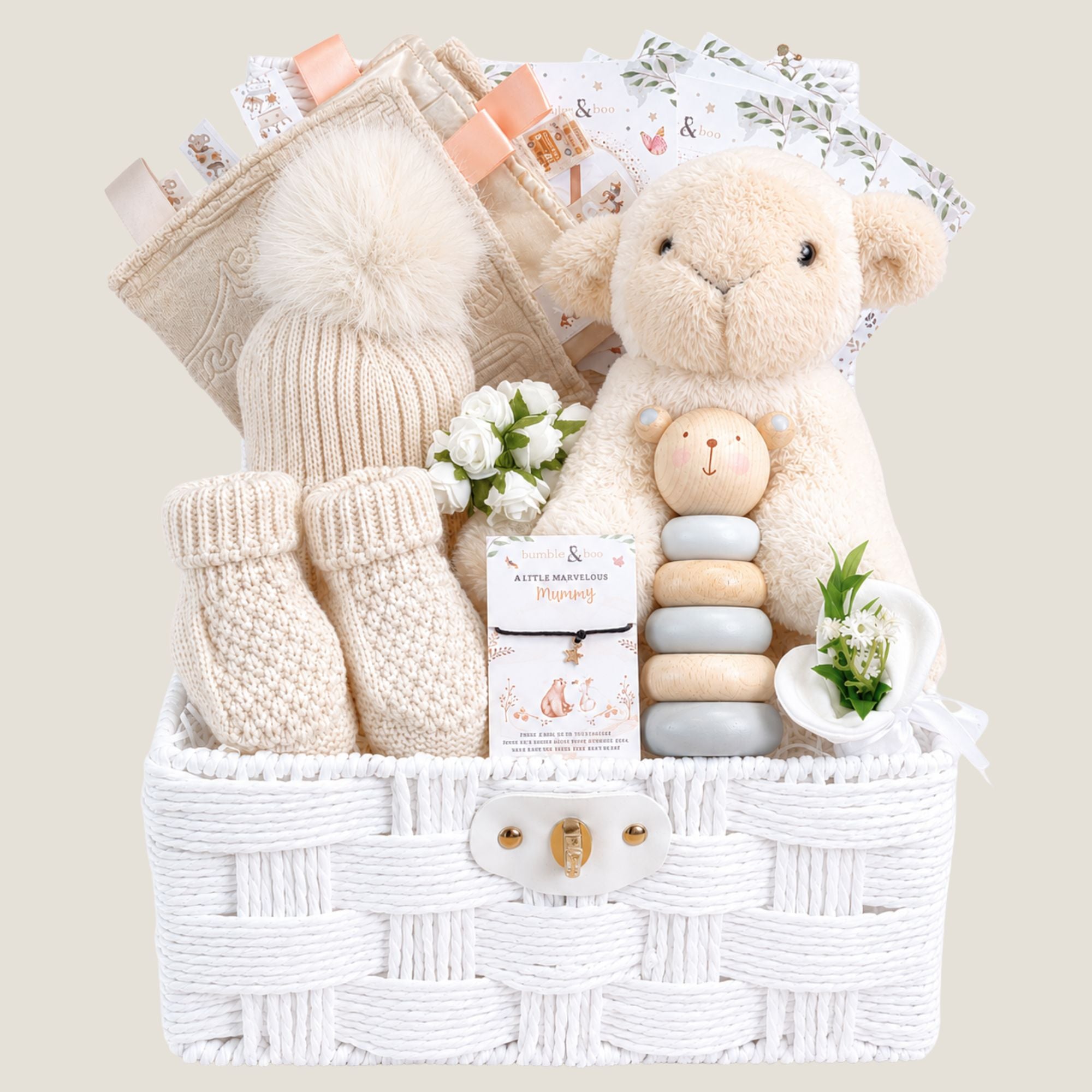 New baby gifts basket with soft beige and cream tones and includes a lamb plus toy.