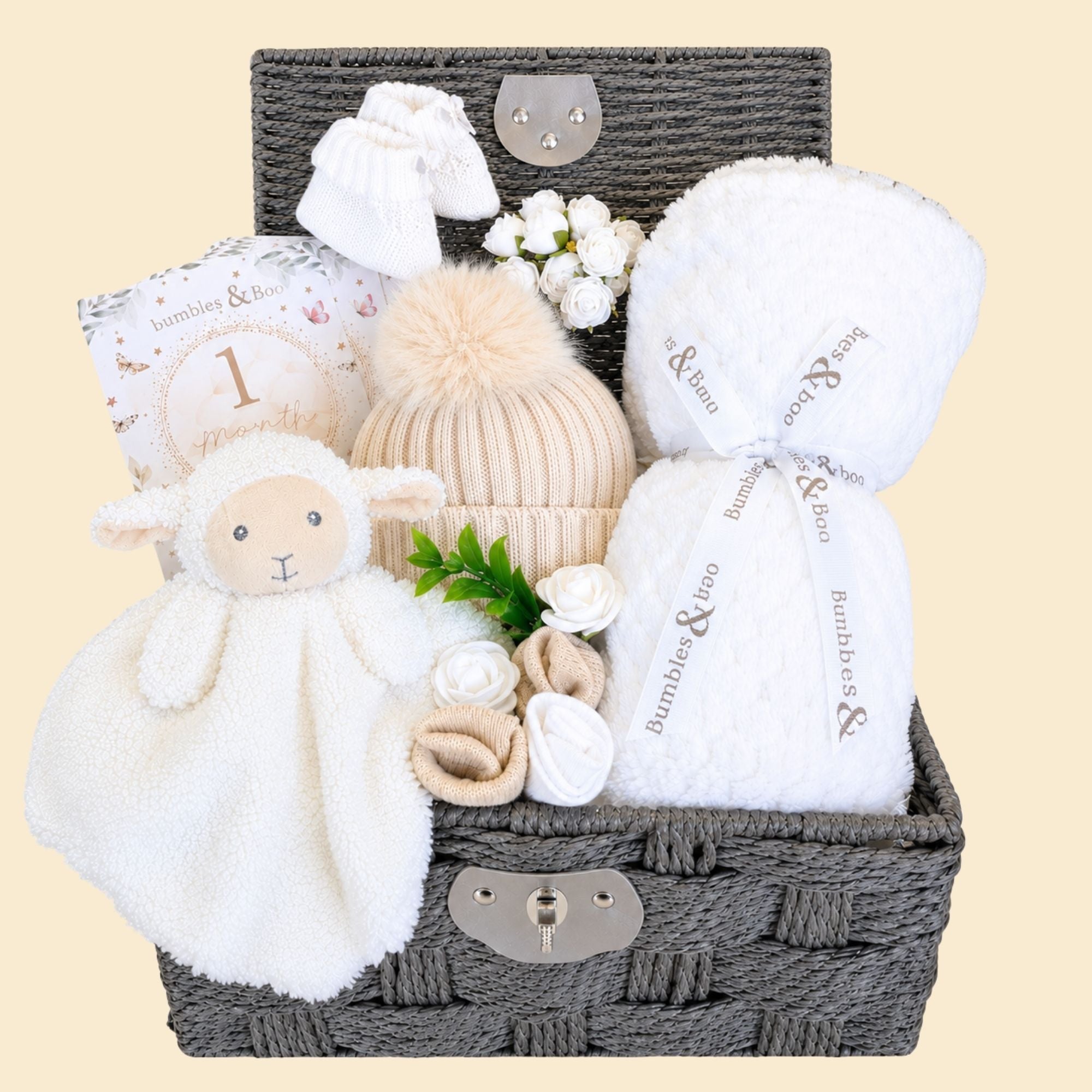 New baby gifts hamper with white baby products in a lidded basket. Bumbles and Boo.