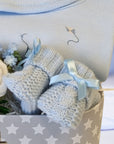 baby boy gifts trunk with blue clothing set and blue knit booties
