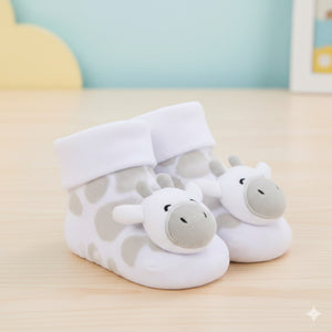 Pair of baby giraffe rattle socks with plush giraffe faces and soft white cuffs, baby clothes for newborns