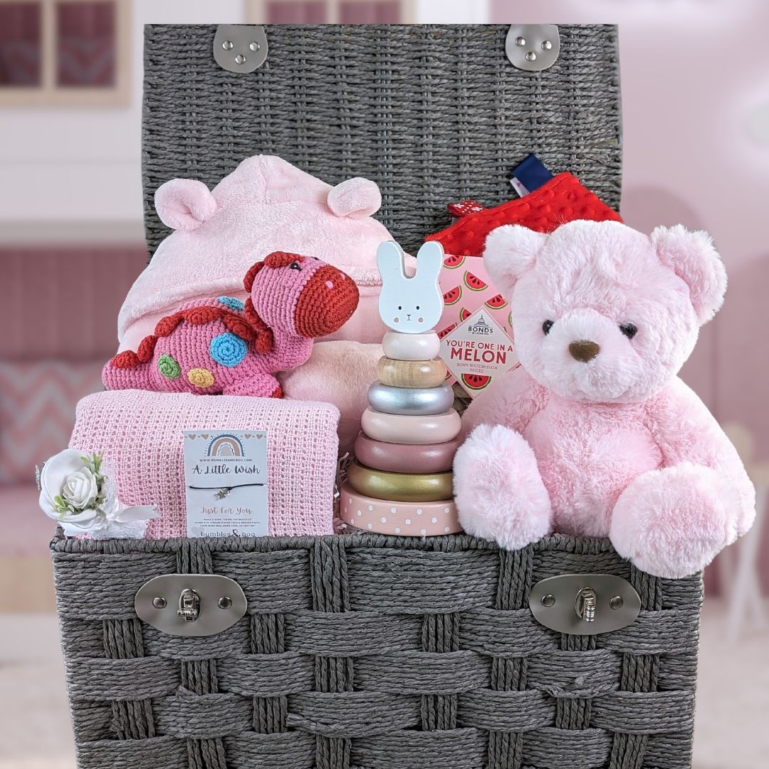 Large baby girl hamper basket with bathrobe, blanket, organic toy, teddy bear and gifts for a new mum.