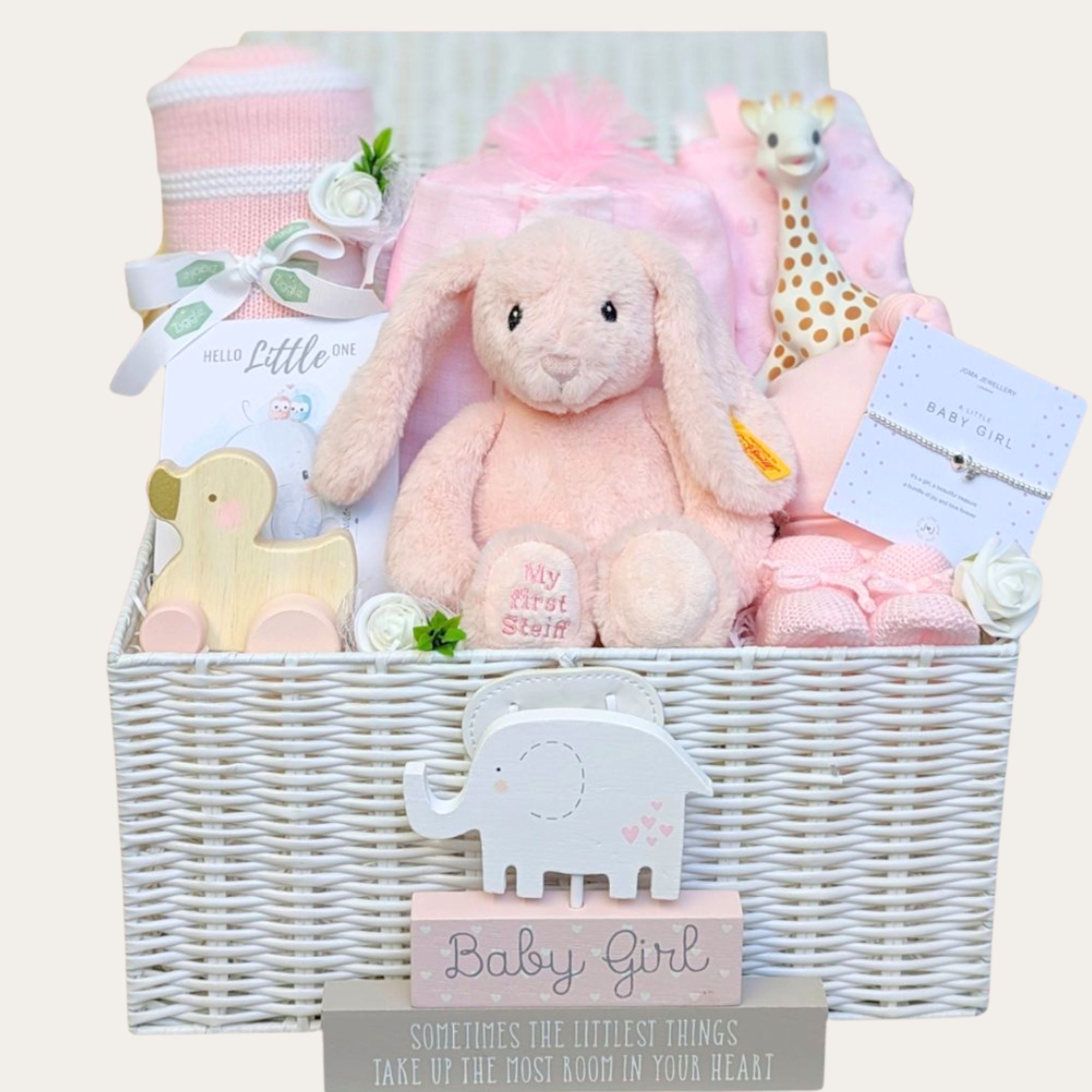 Baby girl basket packed with pink gifts including my first steiff bunny, sophie la giraffe, jewellery for mum and baby blanket. Bumbles and Boo.