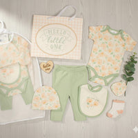 Baby girl clothing set in green and peach floral print with bodysuit, pants, hat, bib and socks. Let Love Grow design.