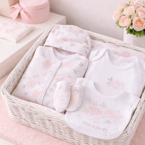 A pink and white floral baby girl clothing set that says little butterfly