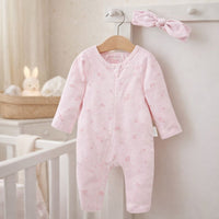 A pink baby girl sleepsuit romper in organic cotton with a pink head band