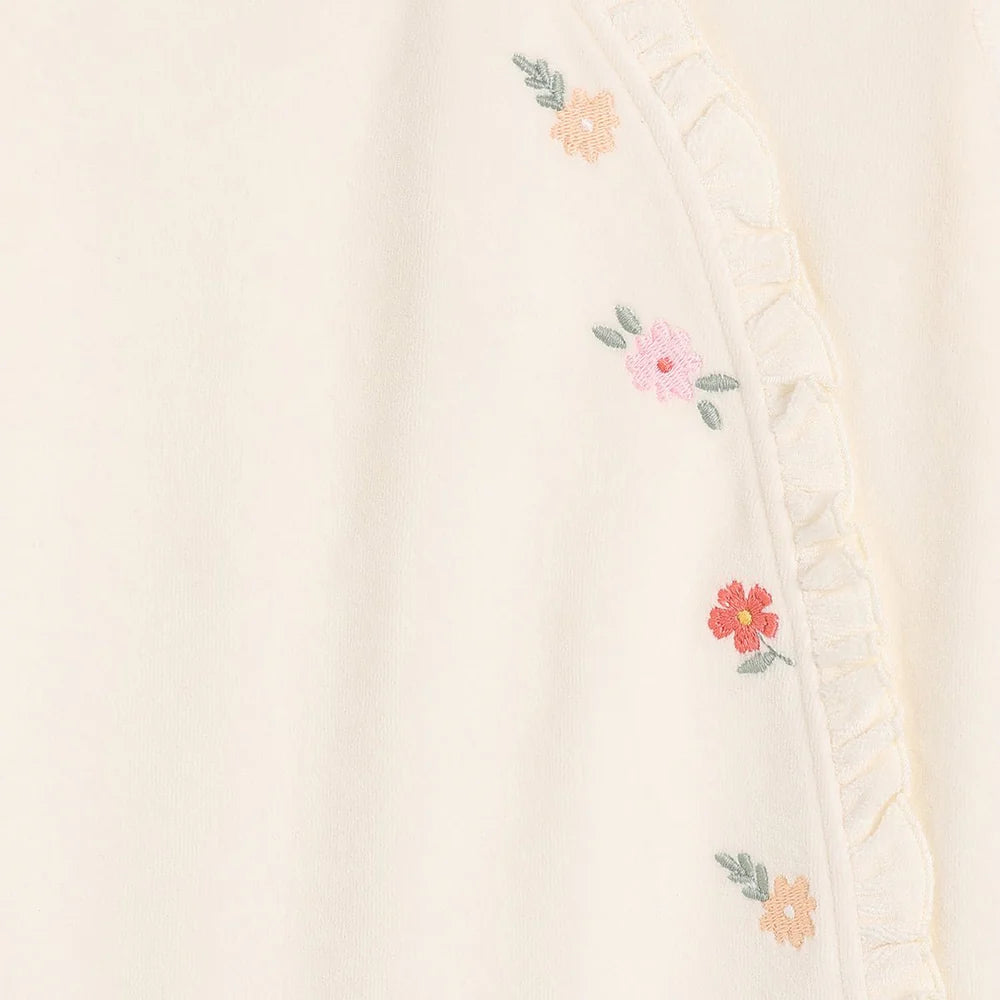 Cream velour baby girl sleepsuit with floral embroidery and frilled side opening