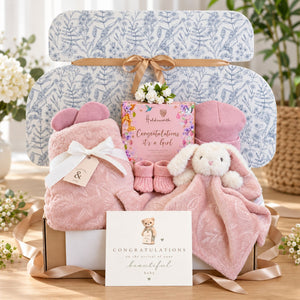 Baby girl gifts box with presents including pink blanket and matching comforter