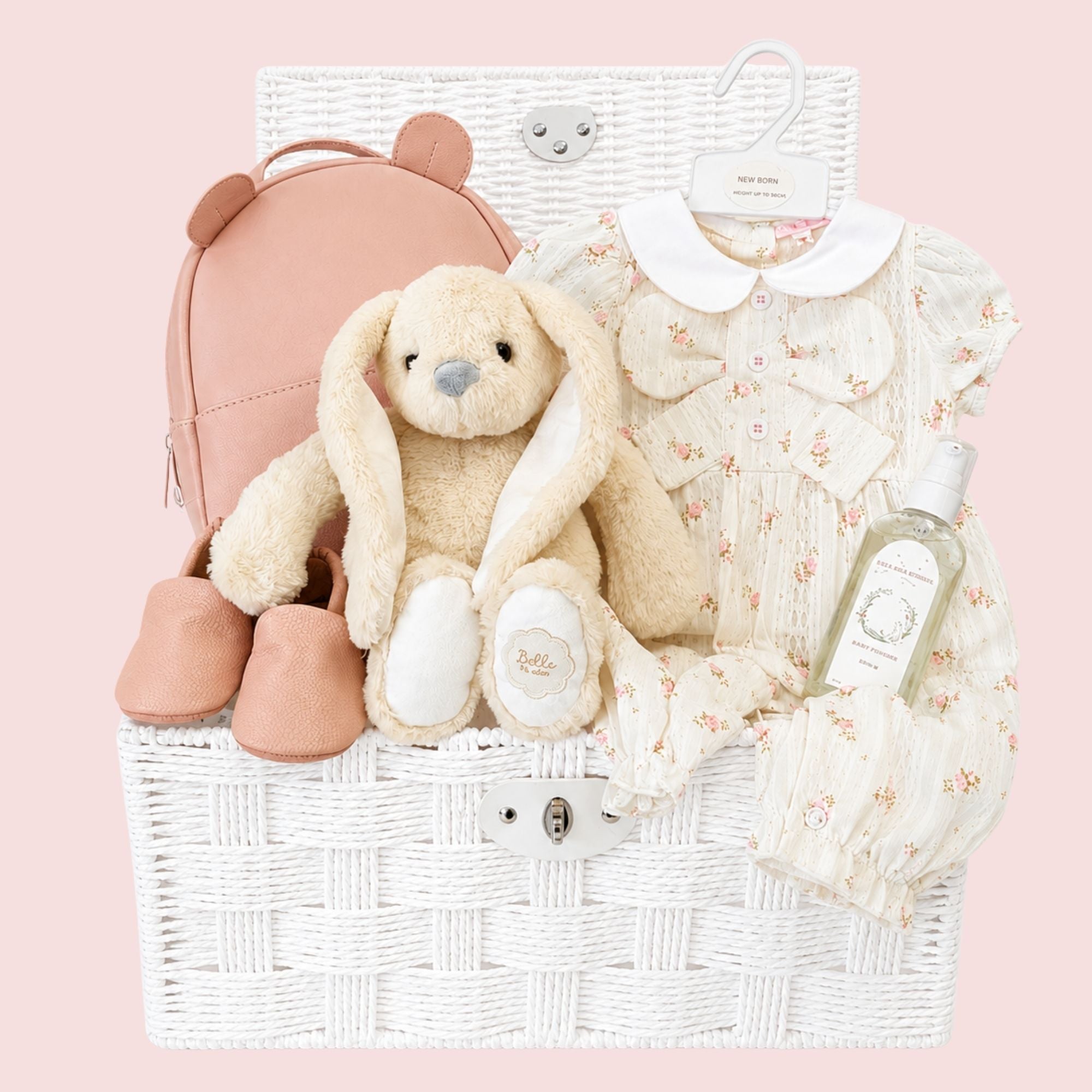 Luxury baby girl gifts hamper featuring a floral romper, plush bunny, baby shoes and keepsake gifts. A beautiful newborn gift for baby girls.