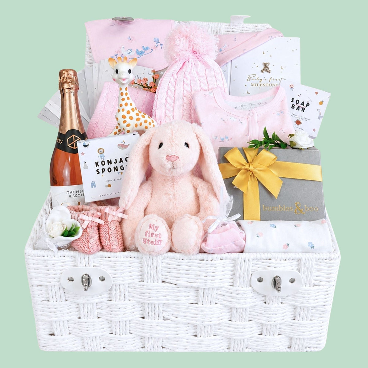 Baby girl gifts in a hamper basket with pink and white presents including pink Steiff bunny and treats for parents.