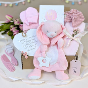 Baby girl gifts box containing pink presents including baby comforter in a eco friendly box. Hamper designed by Bumbles and Boo.