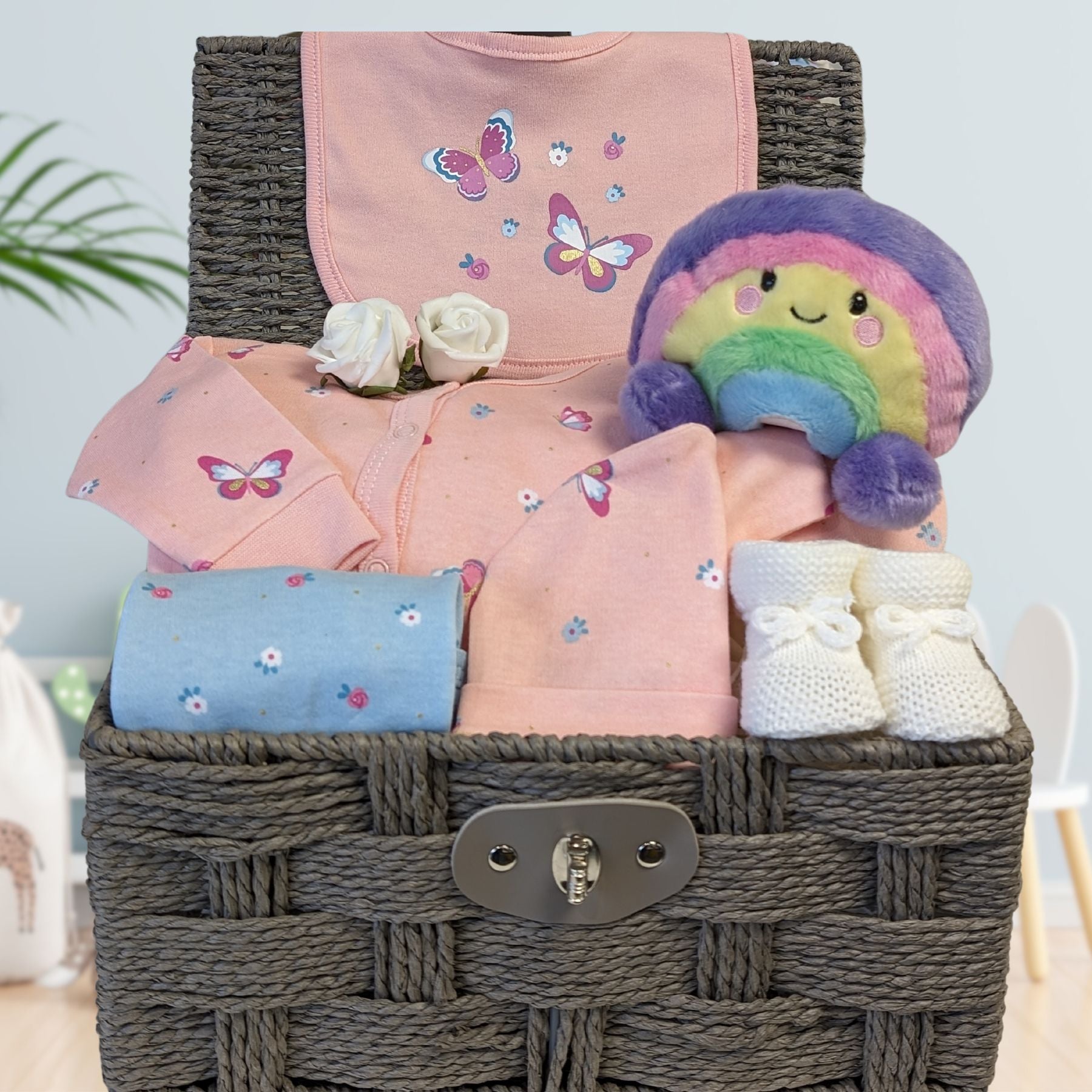 baby girl hamper with butterfly and rainbow theme. Includes rainbow soft toy and baby booties.