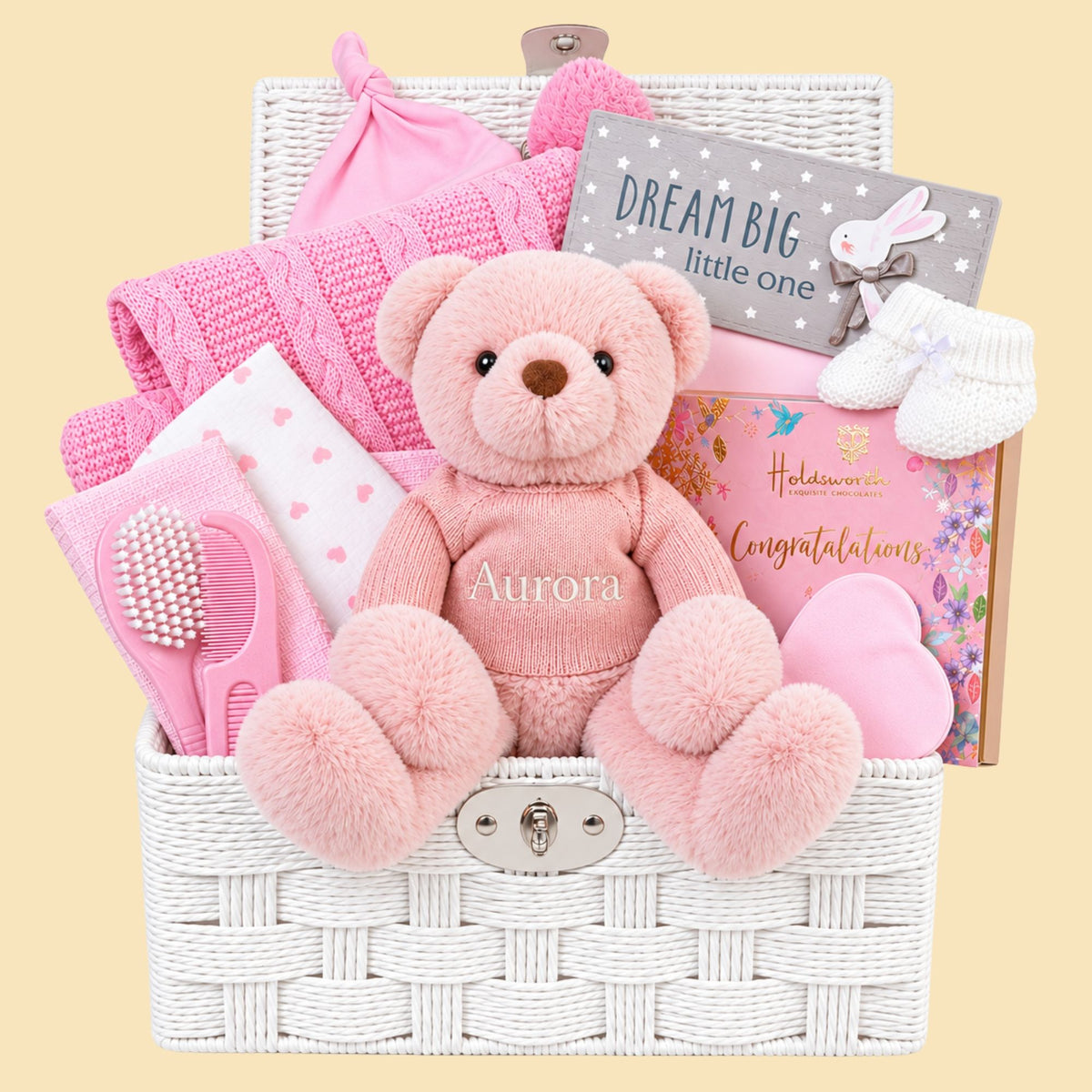 Large baby girl gift hamper basket with personalised teddy bear, pink blanket and chocolates for the new parents.
