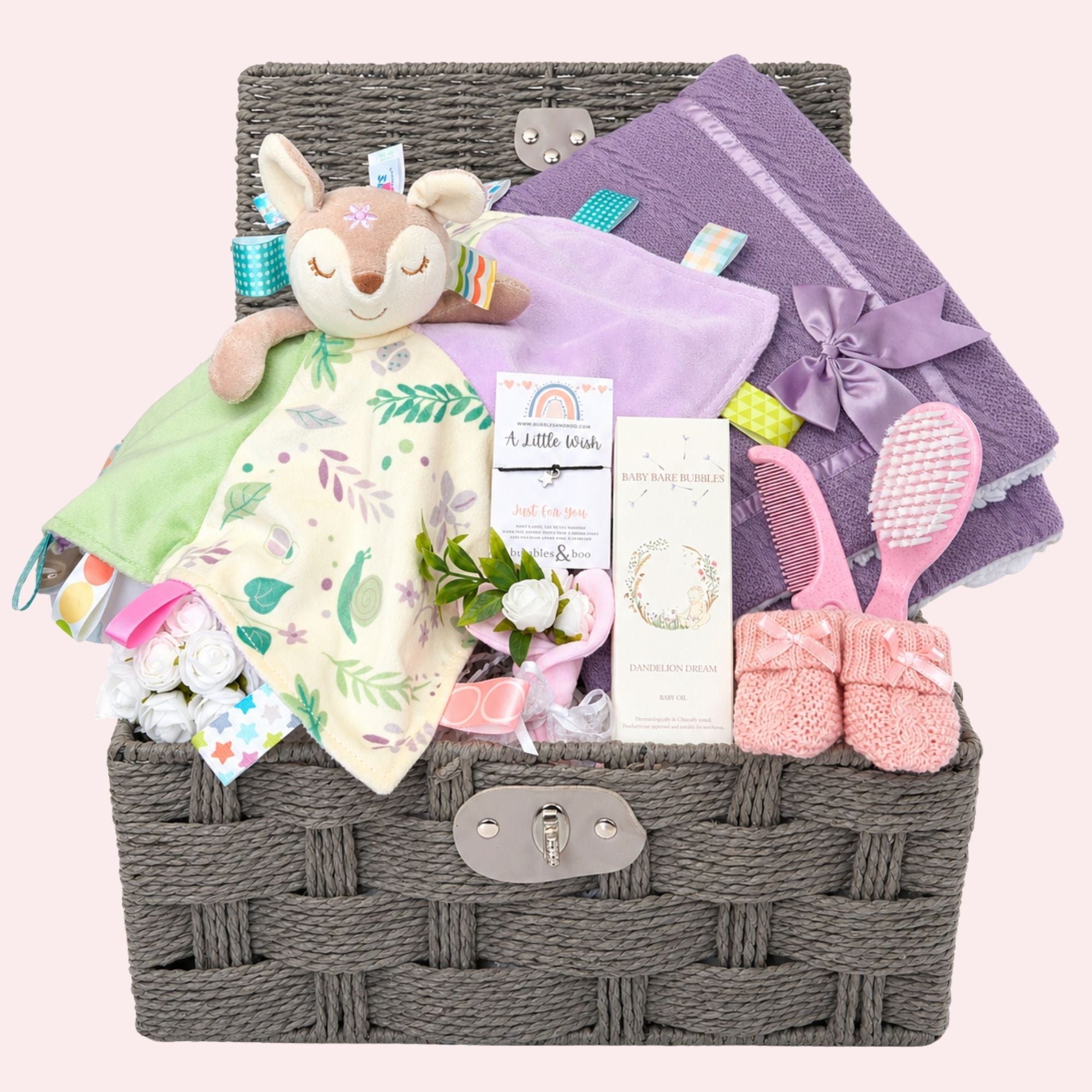 Luxury new baby girl hamper basket with gifts including Flora Fawn taggie comforter by Bumbles and Boo.