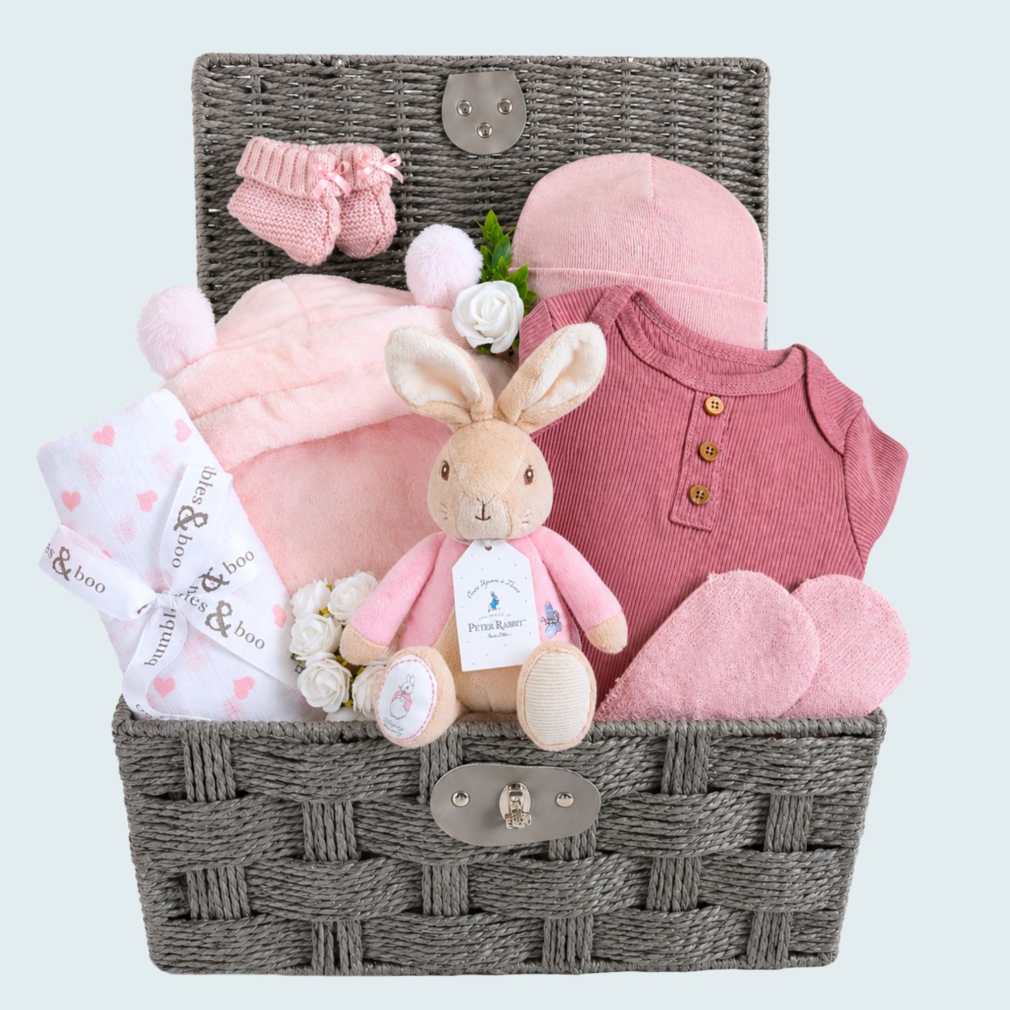 Pink baby girl hamper basket with gifts of a bunny and pink clothes