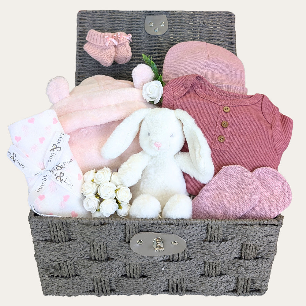 Baby girl hamper gifts basket with pink hooded dressing gown and clothes. Gifts designed by Bumbles and Boo.