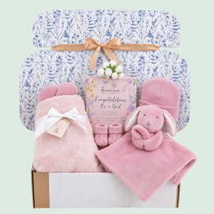 Baby girl gifts hamper box with presents including pink blanket and matching comforter
