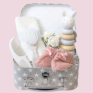 Small baby girl hamper by Bumbles and Boo with pink & white gifts and wooden toy.