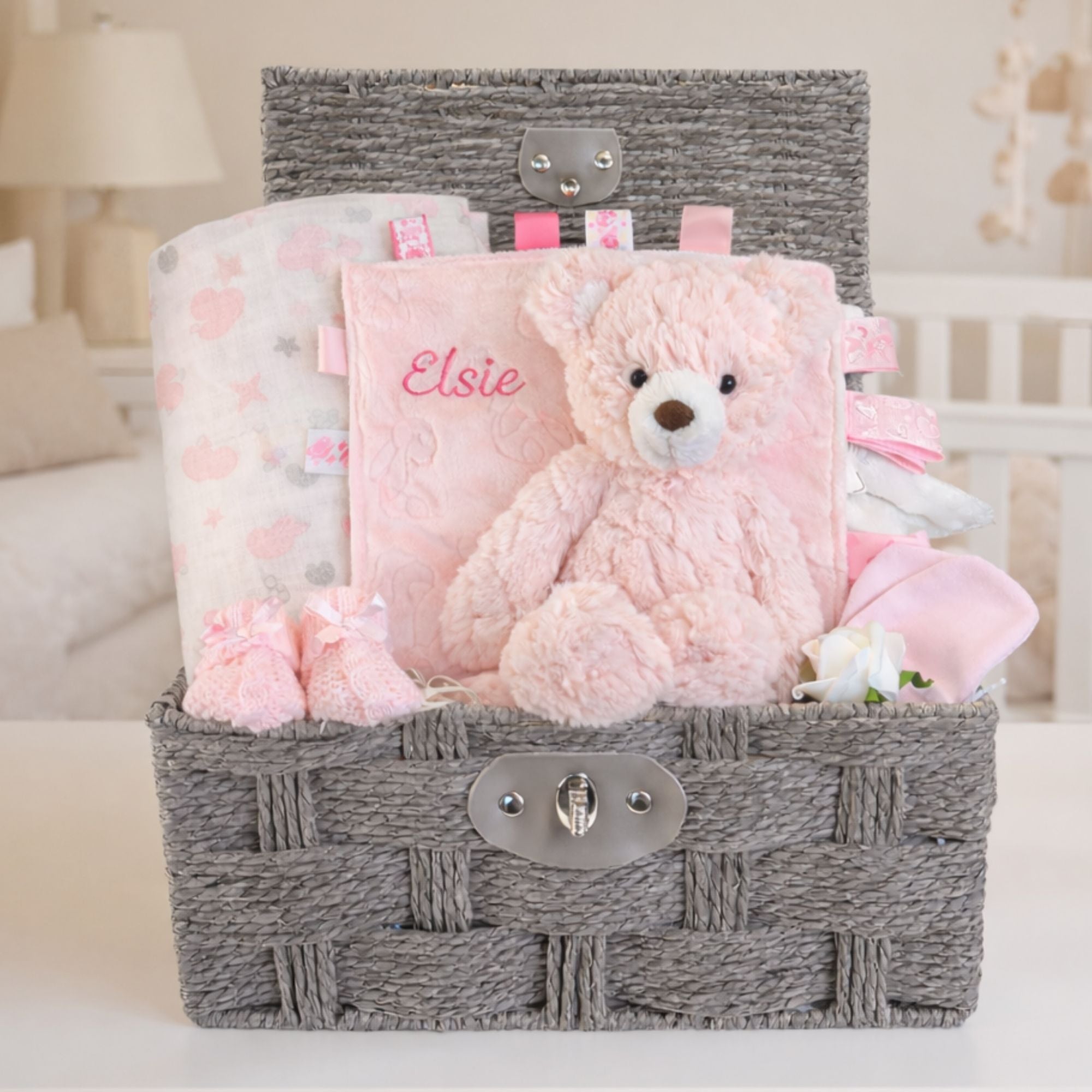 Newborn baby girl gifts hamper with a pink teddy bear and taggie which can be personalised. 