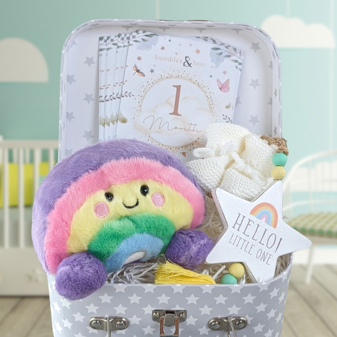 Baby girl gifts trunk with rainbow theme.