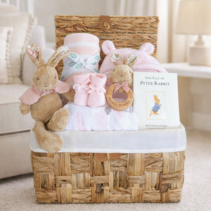 Baby girl hamper basket with gifts including flopsy bunny, baby blanket and bath robe.