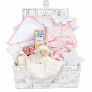 Baby girl hamper basket with pink romper and personalised hooded towel. Little lamb comforter in white.