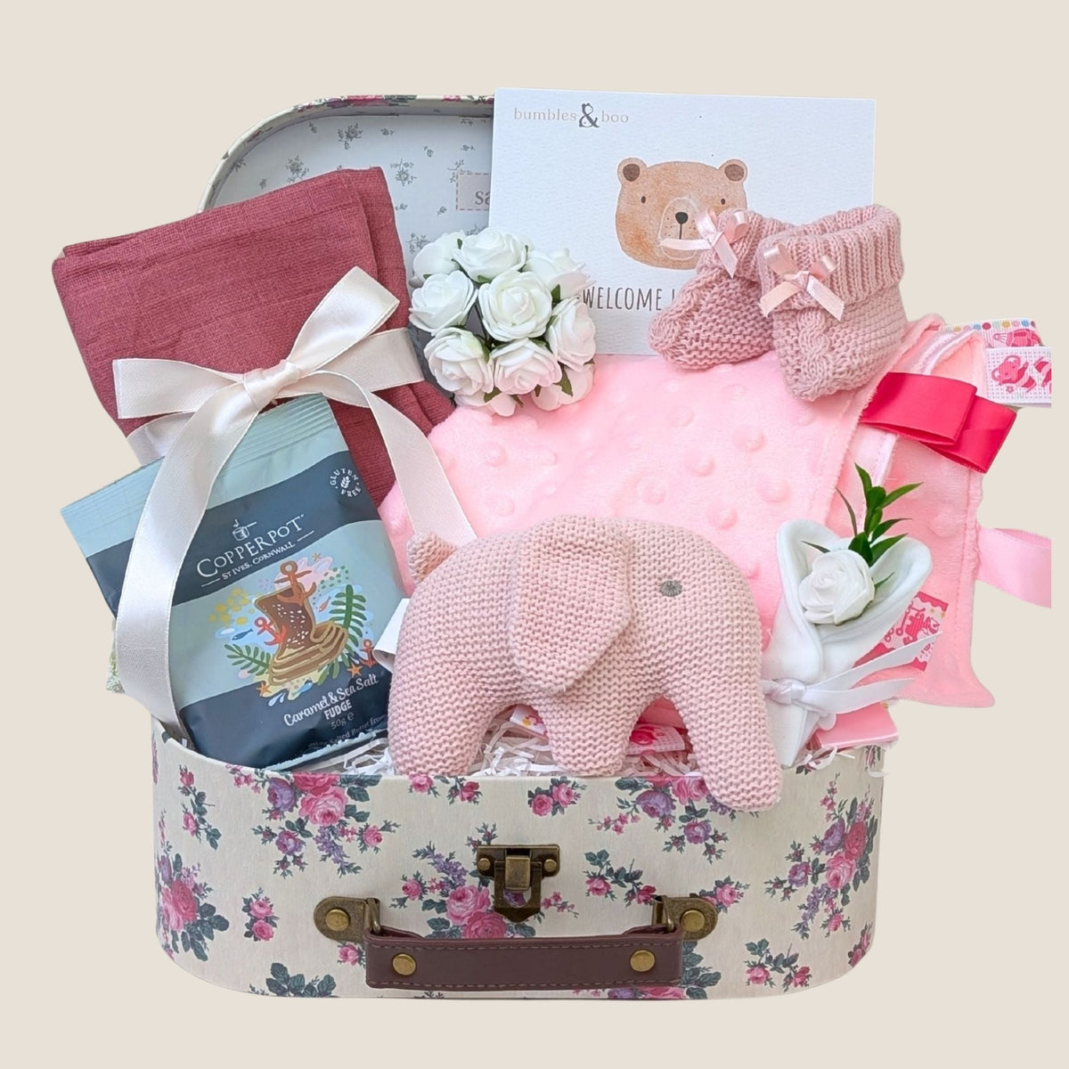 Baby girl hamper with gifts including pink organic elephant toy, comforter and present for parents. 