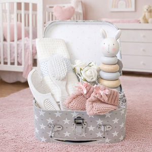 Small baby girl hamper gifts set with brush and comb and wooden stacking bunny toy.