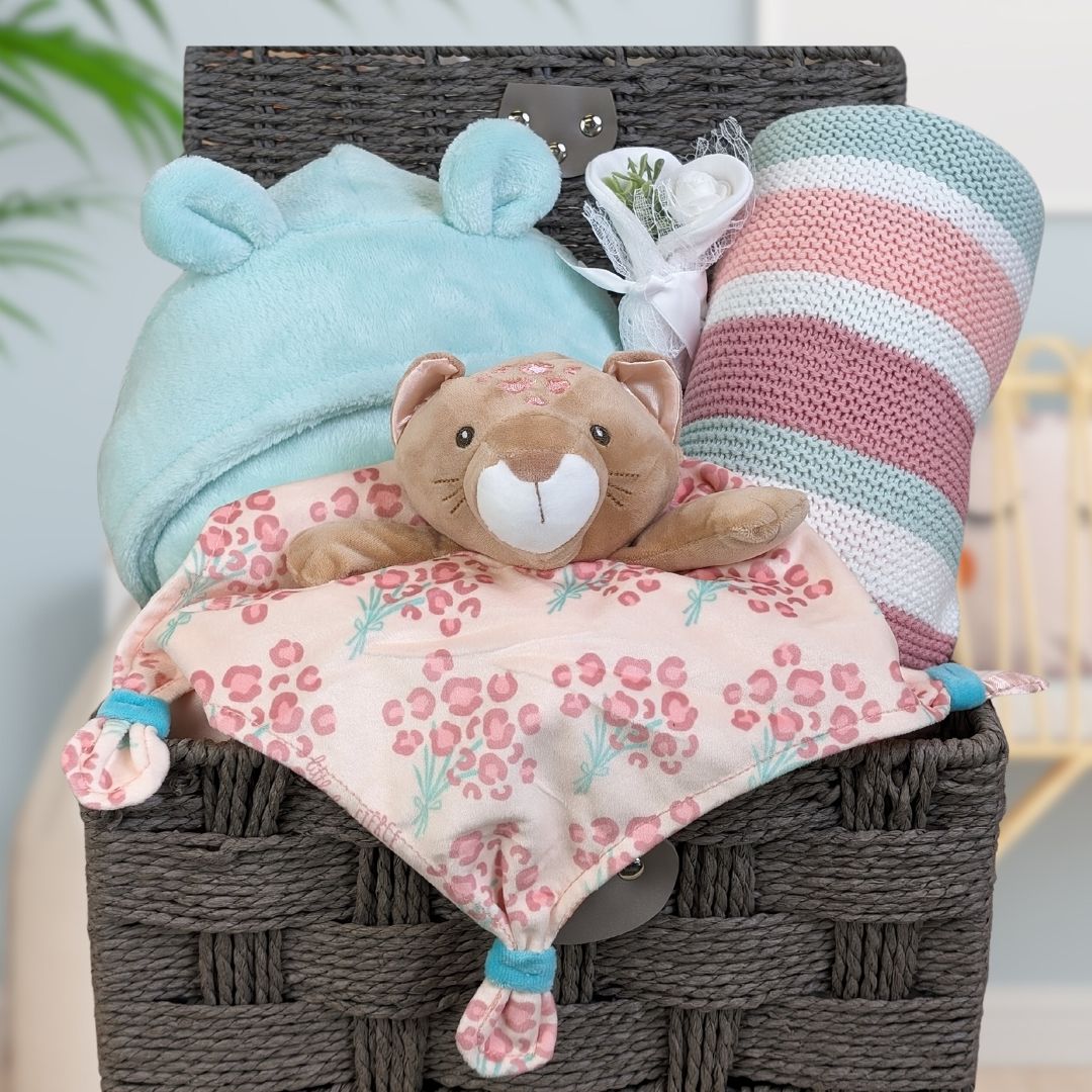 baby girl hamper basket with soft toy, blanket and bath robe.