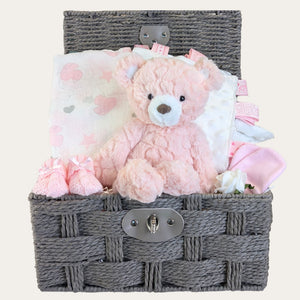 New baby girl gifts hamper basket with presents including pink teddy bear & muslin by Bumbles and Boo.